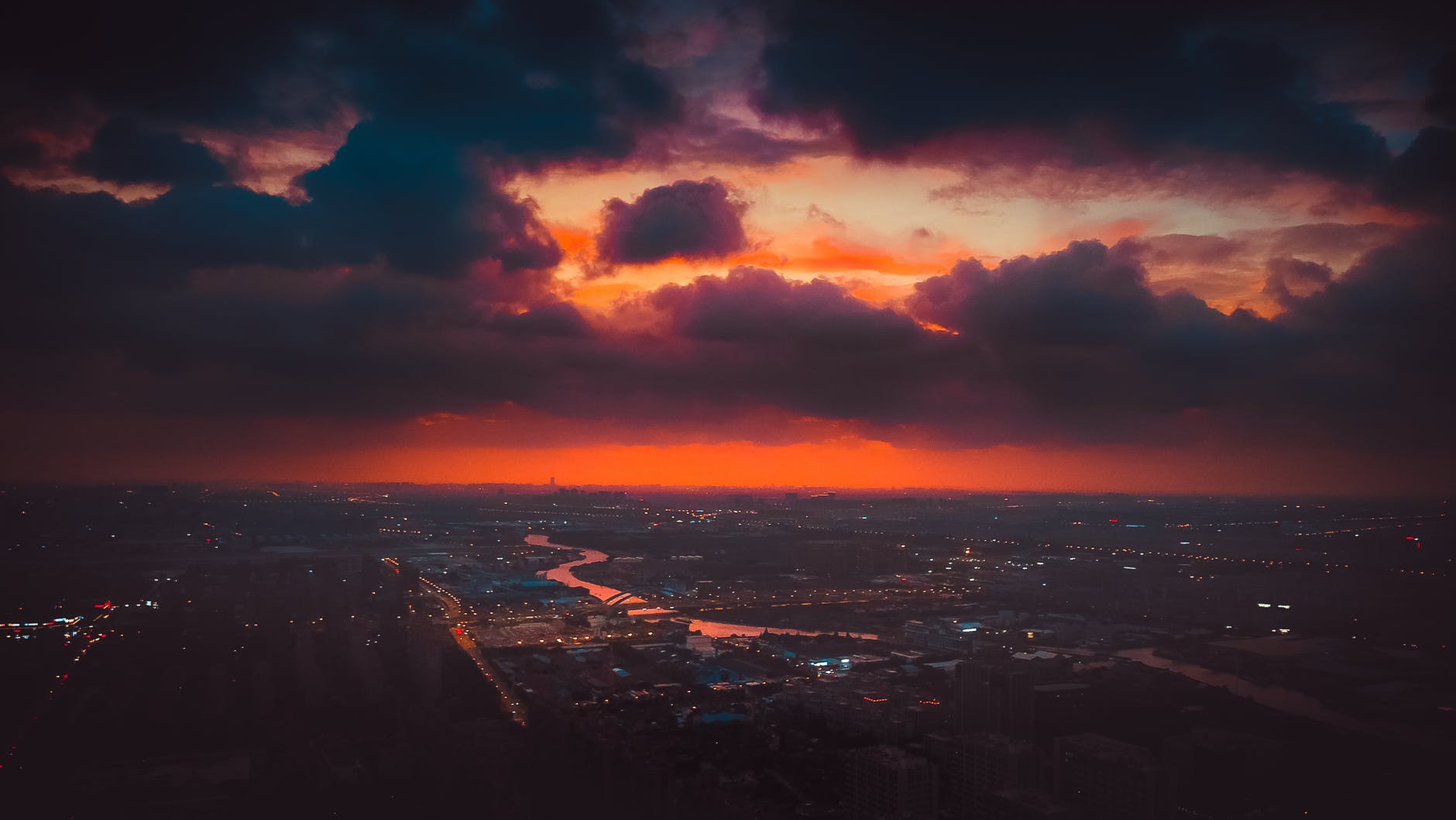 aerial shot of a city under a cinematic sky